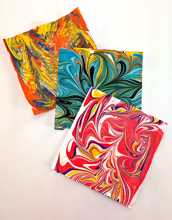 3 paper squares with water marbling designs