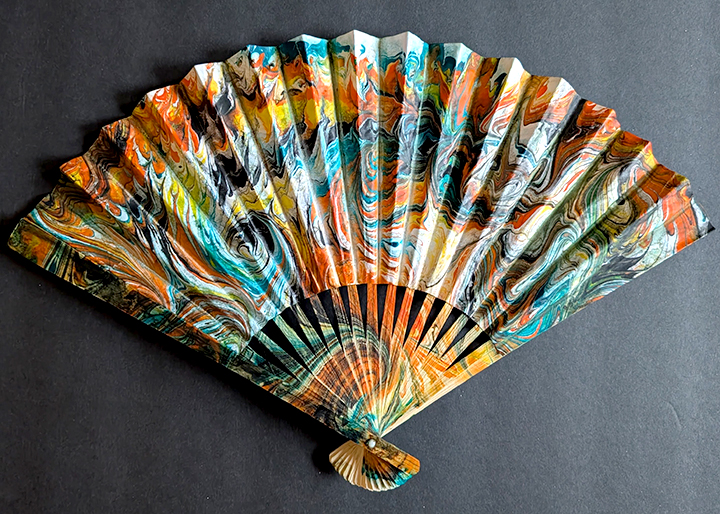 Paper fan with water marbling design